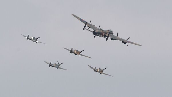 Three Spitfires, a Hurricane and a Lancaster bomber fly over during the VJ Day National Remembrance event, held at the National Memorial Arboretum in Staffordshire, Britain August 15, 2020.  - Sputnik International