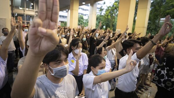 Pro-democracy students raise a three-finger symbol of resistance salute during a protest at Chulalongkorn University in Bangkok, Thailand, Friday, Aug, 14, 2020. Student activists at Thailand's most prestigious university defied a ban by college administrators to stage an anti-government rally Friday, even as a prominent protest leader was arrested elsewhere for his involvement in a previous demonstration.  - Sputnik International