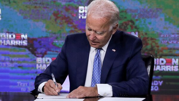 Democratic presidential candidate Joe Biden signs official documents needed to receive his party's official nomination next week during an event in Wilmington, Delaware, U.S., August 14, 2020. - Sputnik International