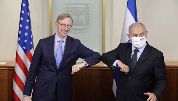 Israeli Prime Minister Benjamin Netanyahu, right, and US special envoy for Iran, Brian Hook, touch elbows to help prevent the spread of the coronavirus, at the Prime Minister's office in Jerusalem, Tuesday June 30, 2020 - Sputnik International