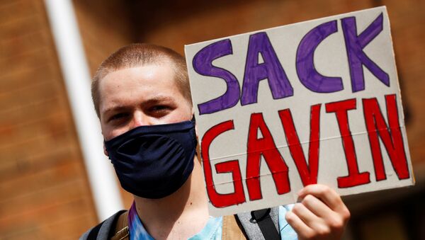 A-level student holds a placard during a protest about the exam results at the constituency offices of Education Secretary Gavin Williamson, amid the spread of the coronavirus disease (COVID-19), in South Staffordshire, Britain, August 17, 2020 - Sputnik International