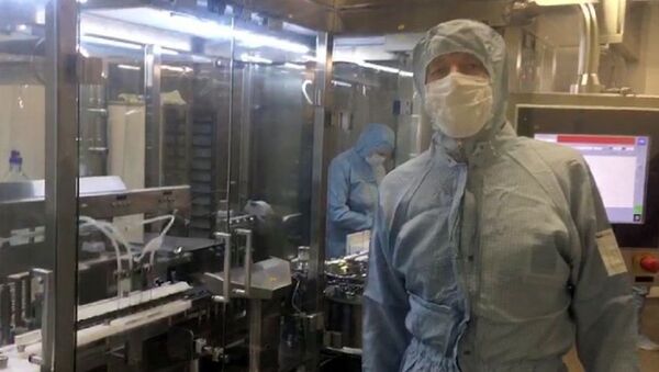 In this handout video grab released by Russian Healthcare Ministry, an employee works at a production line of the world's first vaccine against COVID-19 registered in Russia, in Moscow, Russia. On August 11, Russia announced registering the world's first coronavirus vaccine, dubbed Sputnik V, set to be produced industrially - Sputnik International