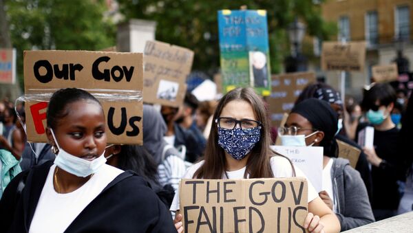 An A level student holds a placard during a protest opposite Downing Street, amid the outbreak of the coronavirus disease (COVID-19), in London, Britain, August 16, 2020. REUTERS/Henry Nicholls/File Photo - Sputnik International