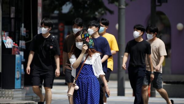 Pedestrians wearing masks to prevent the spread of the coronavirus disease (COVID-19) walk in a shopping district in Seoul, South Korea, August 20, 2020.  - Sputnik International