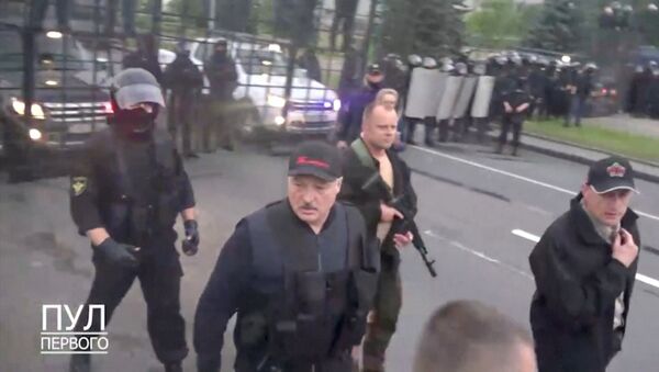 Belarusian President Alexander Lukashenko walks outside the Independence Palace after an opposition demonstration against presidential election results, in Minsk, Belarus, in this in this still image from a handout video taken August 23, 2020. Video taken August 23, 2020. Courtesy of POOL PERVOGO/Handout via REUTERS TV  - Sputnik International