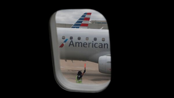 FILE PHOTO: An airlines worker signals next to an American Airlines plane that arrived at Hartsfield–Jackson Atlanta International Airport, as the coronavirus disease (COVID-19) continues, in Atlanta, Georgia, U.S., May 19, 2020. REUTERS/Shannon Stapleton/File Photo - Sputnik International