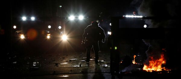 A police officer removes a barricade erected by demonstrators during a protest against police violence and racial injustice in Portland, Oregon, US, August 23, 2020 - Sputnik International