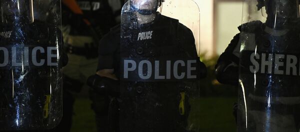 Police and members of the Sheriff's department hold a perimeter, during a protest after a Black man identified as Jacob Blake was shot several times by police last night, outside the Kenosha County Courthouse in Kenosha, Wisconsin, U.S. August 24, 2020 Police and members of the Sheriff's department hold a perimeter, during a protest after a Black man identified as Jacob Blake was shot several times by police last night, outside the Kenosha County Courthouse in Kenosha, Wisconsin, U.S. August 24, 2020 - Sputnik International