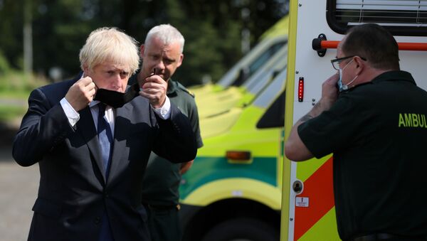 Britain's Prime Minister Boris Johnson puts on a mask at the Northern Ireland Ambulance Service HQ during his visit to Belfast, Northern Ireland, 13 August 2020 - Sputnik International