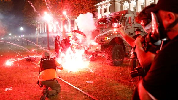 Flares go off in front of a Kenosha Country Sheriff Vehicle as demonstrators take part in a protest following the police shooting of Jacob Blake, a Black man, in Kenosha, Wisconsin, U.S. August 25, 2020. - Sputnik International