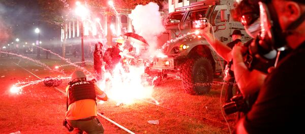 Flares go off in front of a Kenosha Country Sheriff Vehicle as demonstrators take part in a protest following the police shooting of Jacob Blake, a Black man, in Kenosha, Wisconsin, U.S. August 25, 2020. - Sputnik International