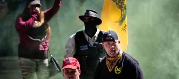Right-wing affiliated counter-protester Tusitala Tiny Toese reacts after being caught in a cloud of pepper spray during clashes between far-right groups and protesters who have been demonstrating against police brutality and racial injustice in Portland, Oregon, US, August 22, 2020 - Sputnik International
