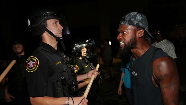 A man confronts police outside the Kenosha Police Department in Kenosha, Wisconsin, U.S., during protests following the police shooting of Black man Jacob Blake, August 23, 2020 - Sputnik International