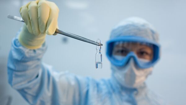 A handout photo shows an employee demonstrating a vial with Gam-COVID-Vac vaccine against the coronavirus disease (COVID-19), developed by the Gamaleya National Research Institute of Epidemiology and Microbiology and the Russian Direct Investment Fund (RDIF), during its production at Binnopharm pharmaceutical company in Zelenograd near Moscow, Russia August 7, 2020 - Sputnik International