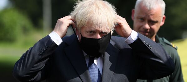 Britain's Prime Minister Boris Johnson puts on a mask at the Northern Ireland Ambulance Service HQ during his visit to Belfast, Northern Ireland August 13, 2020. Britain's Prime Minister Boris Johnson puts on a mask at the Northern Ireland Ambulance Service HQ during his visit to Belfast, Northern Ireland August 13, 2020. - Sputnik International