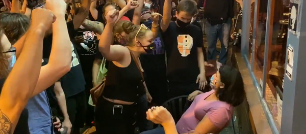 A screenshot from a video showing BLM protestors confronting diners outside a DC restaurant A screenshot from a video showing BLM protestors confronting diners outside a DC restaurant - Sputnik International