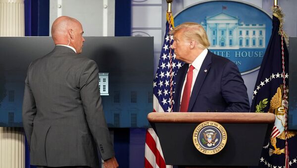 A Secret Service agent escorts U.S. President Donald Trump from a coronavirus disease (COVID-19) pandemic briefing after a shooting outside the White House in Washington, U.S., August 10, 2020. - Sputnik International