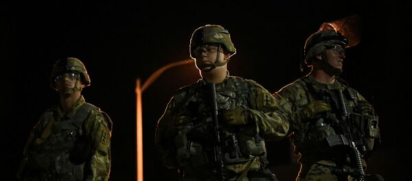 Members of the Wisconsin National Guard keep watch at their post behind the Kenosha Police Department building following the police shooting of Jacob Blake, a Black man, in Kenosha, Wisconsin, U.S., August 27, 2020. - Sputnik International