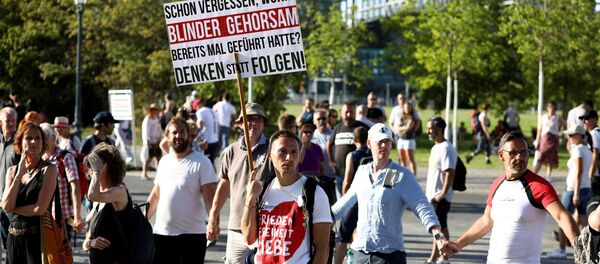 Germans take part in a protest against the government's restrictions imposed over the coronavirus outtbreak, in Berlin, Germany, 1 August 2020. - Sputnik International