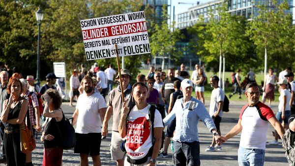 Germans take part in a protest against the government's restrictions imposed over the coronavirus outtbreak, in Berlin, Germany, 1 August 2020. - Sputnik International