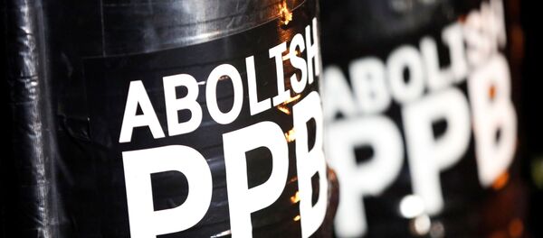 A sign reading Abolish PPB is seen on shields held by demonstrators - Sputnik International