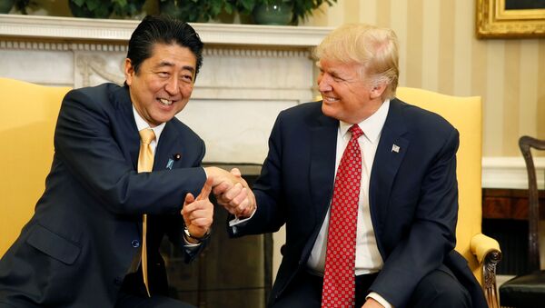 Japanese Prime Minister Shinzo Abe shakes hands with U.S. President Donald Trump (R) during their meeting in the Oval Office at the White House in Washington, U.S., February 10, 2017. - Sputnik International