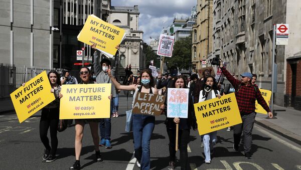 People take part in a protest over the governments handling of exam results, outside the Department for Education, amid the spread of the coronavirus disease (COVID-19), in London, Britain, August 22, 2020 - Sputnik International