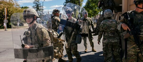 National Guard officers unload an armoured vehicle filled with soldiers outside of the Kenosha County Courthouse during a Blue Lives Matter rally organized by supporters of law enforcement officers, a week after Black man Jacob Blake was shot several times by police in Kenosha, Wisconsin, U.S., August 30, 2020.  - Sputnik International