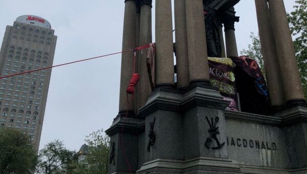 The statue of John A. Macdonald, Canada's first prime minister, is pulled down by demonstrators during a protest against racial inequality, in Montreal, Quebec, Canada August 29, 2020 in this picture obtained from social media.  - Sputnik International