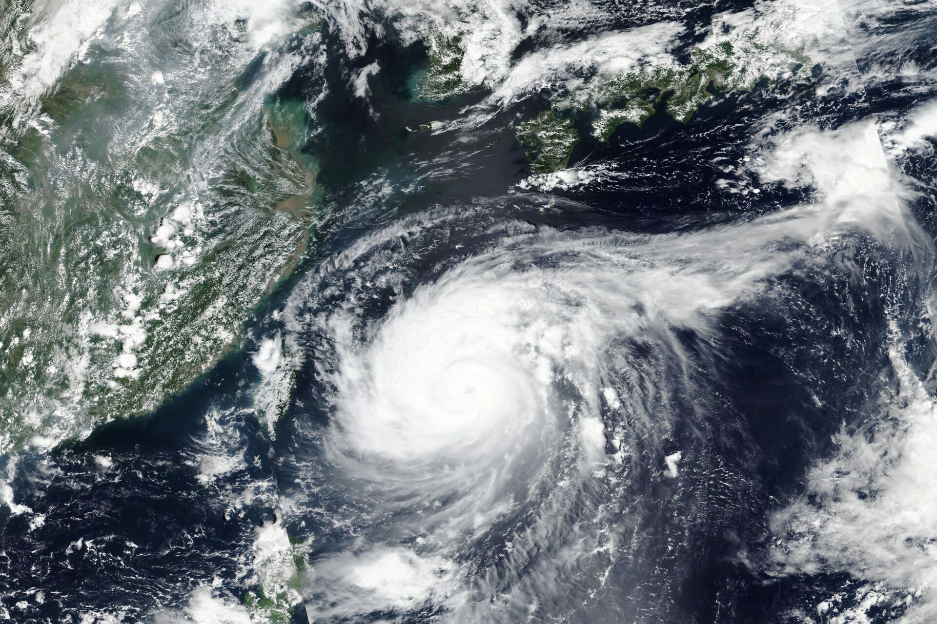 This Monday, Aug. 31, 2020, satellite image released by NASA shows Typhoon Maysak over Japan's southernmost islands, including Okinawa, center. The powerful typhoon was blowing over Japan's southernmost islands early Tuesday on course for Japan's main southern island and later the Korean Peninsula. Warnings issued for the area around Okinawa, home to U.S. military bases, said strong gusts could cause some homes to collapse and extremely high tides were a risk as well. - Sputnik International, 1920, 18.09.2022