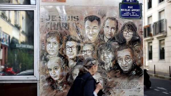 A woman walks past a painting by French street artist and painter Christian Guemy, known as C215, in tribute to members of Charlie Hebdo newspaper who were killed by jihadist gunmen in January 2015, in Paris, on August 31, 2020. - Fourteen alleged accomplices in the 2015 jihadist attacks on the Charlie Hebdo satirical weekly, on a kosher supermarket and in the southern Paris suburb Montrouge go on trial on September 2, more than half-a-decade after days of bloodshed that still shock France. The attacks heralded a wave of Islamist violence that has left 258 people dead and raised unsettling questions about modern France's ability to preserve security and harmony for a multicultural society. - Sputnik International