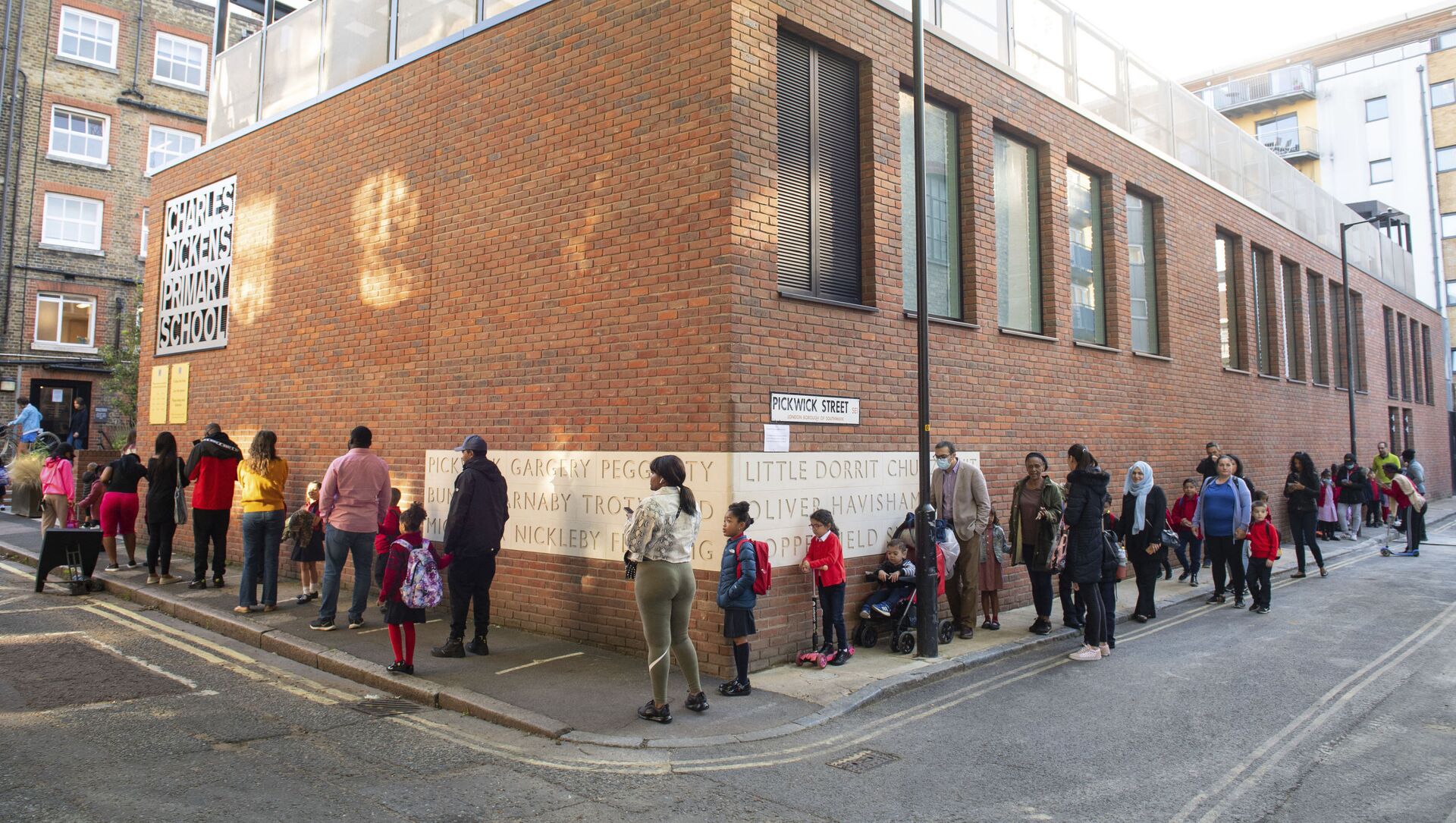 Pupils and parents queue on the first day back to school at Charles Dickens Primary School in London, Tuesday Sept. 1, 2020. Hundreds of thousands of British schoolchildren are heading back to classrooms, with the country watching nervously to see if reopening schools brings a surge in coronavirus infections. Tuesday marks the start of term for about 40% of schools in England and Wales, with the rest reopening in the coming days.  - Sputnik International, 1920, 25.02.2021