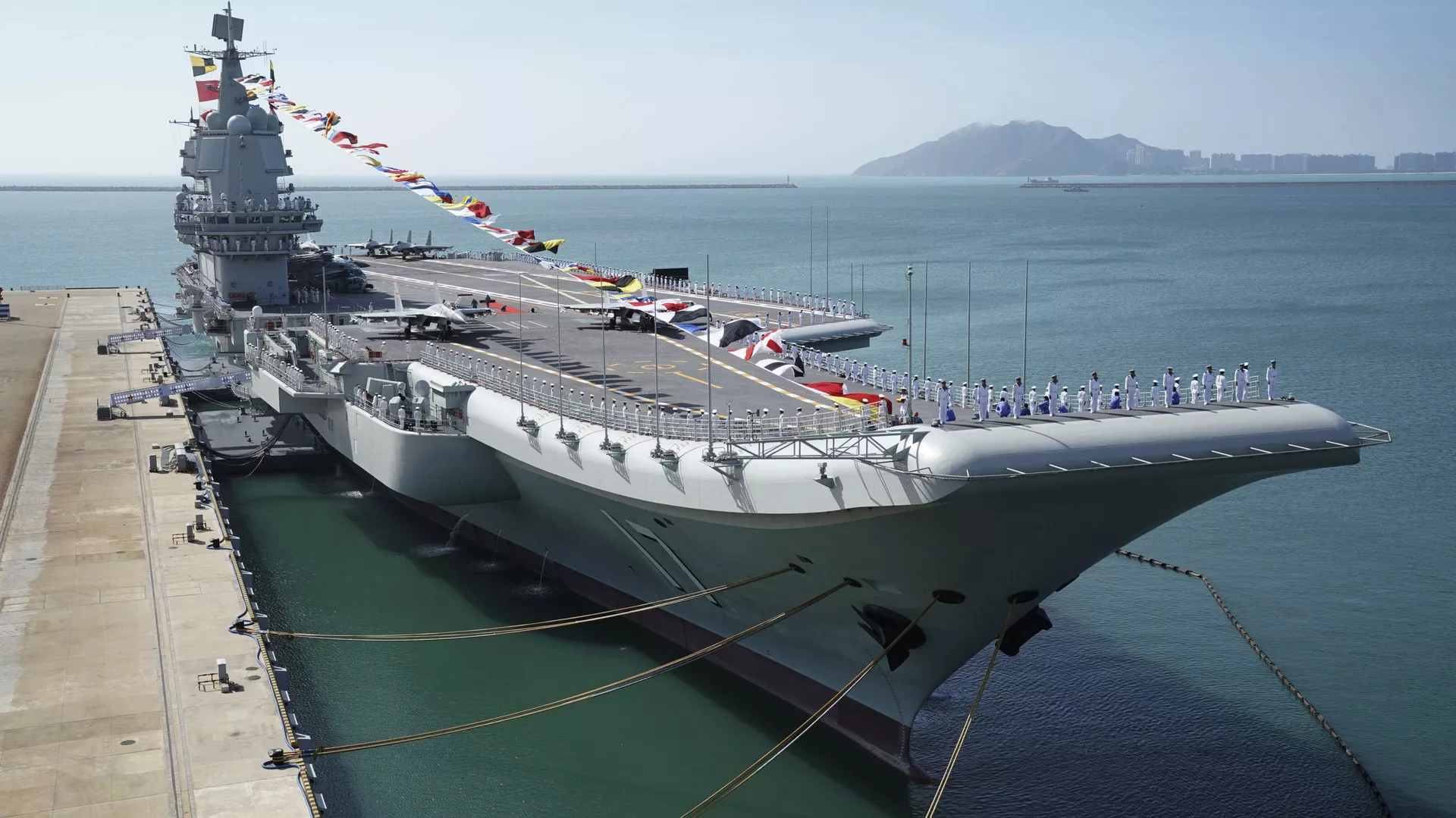 FILE - In this Dec. 17, 2019, file photo provided by Xinhua News Agency, the Shandong aircraft carrier is docked at a naval port in Sanya in southern China's Hainan Province - Sputnik International, 1920, 11.09.2023