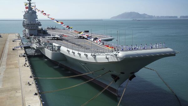 FILE - In this Dec. 17, 2019, file photo provided by Xinhua News Agency, the Shandong aircraft carrier is docked at a naval port in Sanya in southern China's Hainan Province - Sputnik International