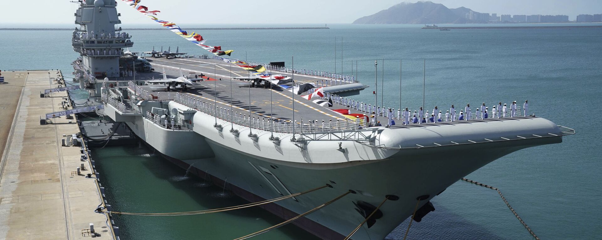 FILE - In this Dec. 17, 2019, file photo provided by Xinhua News Agency, the Shandong aircraft carrier is docked at a naval port in Sanya in southern China's Hainan Province - Sputnik International, 1920, 23.02.2021