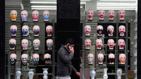 A member of the public walks past a shop selling face masks for the COVID-19 pandemic in Glasgow on September 2, 2020. The Scottish government imposed fresh restrictions on the city after a rise in cases of the novel coronavirus.  - Sputnik International