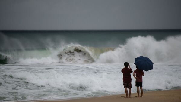 Two men watch the waves during swells brought by the approaching typhoon Maysak on Haeundae beach in Busan on September 2, 2020. - Flights were grounded in South Korea and storm warnings issued on both sides of the Korean peninsula as a typhoon forecast to be one of the most powerful in years made its approach. - Sputnik International