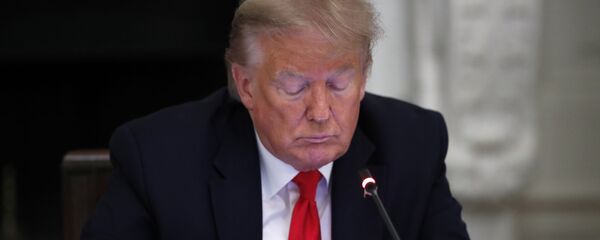 President Donald Trump looks at his phone during a roundtable with governors on the reopening of America's small businesses, in the State Dining Room of the White House, Thursday, June 18, 2020, in Washington - Sputnik International