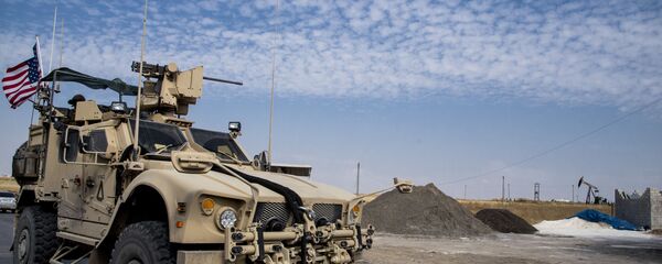 FILE - In this Monday, Oct. 28, 2019 file photo, U.S. forces patrol Syrian oil fields, in eastern Syria.President Donald Trump's decision to dispatch new U.S. forces to eastern Syria to secure oil fields is being criticized by some experts as ill-defined and ambiguous. But the residents of the area, one of the country's most remote and richest regions, hope the U.S. focus on eastern Syria would bring an economic boon and eliminate what remains of the Islamic State group - Sputnik International