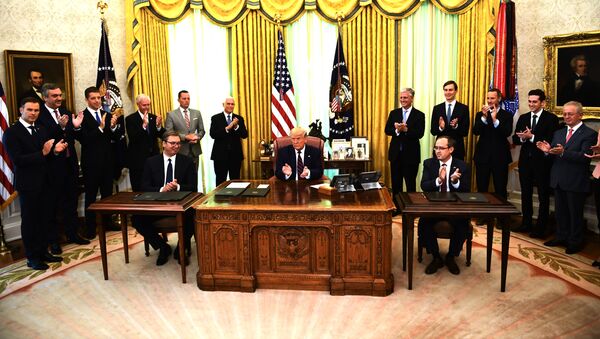 US President Donald Trump applauds after Kosovar Prime Minister Avdullah Hoti (R) and Serbian President Aleksandar Vucic (L) signed an agreement on opening economic relations, in the Oval Office of the White House in Washington, DC, on September 4, 2020 - Sputnik International