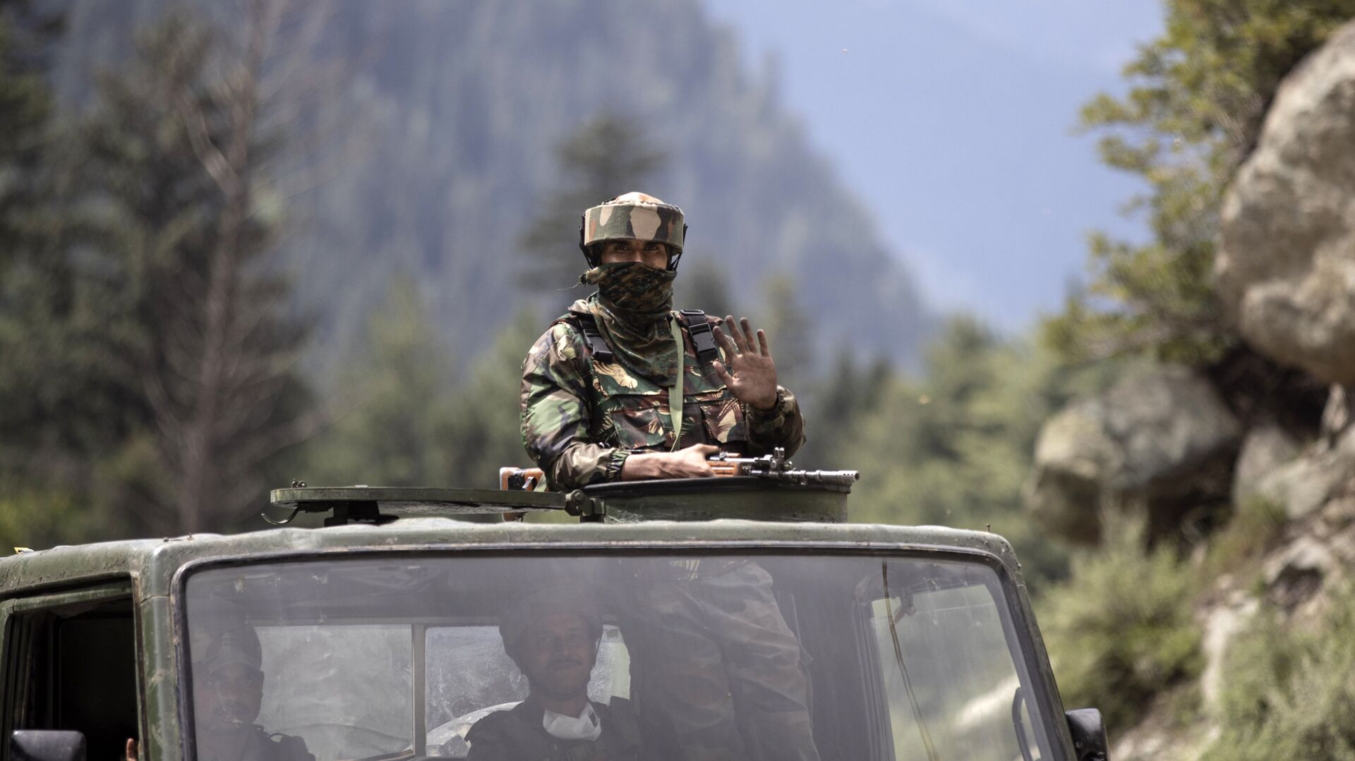 An Indian army soldier keeps guard on top of his vehicle as their convoy moves on the Srinagar- Ladakh highway at Gagangeer, northeast of Srinagar, Indian-controlled Kashmir, Tuesday, Sept. 1, 2020 - Sputnik International, 1920, 31.08.2021