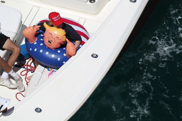 A boater wears a Trump hat and inner tube to show support for President Donald Trump during a parade down the Intracoastal Waterway to just off the shore of President Trump's home at Mar-a-Lago on September 07, 2020 in West Palm Beach, Florida.  - Sputnik International