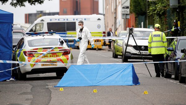 Police officers and a forensic worker are seen at the scene of reported stabbings in Birmingham, Britain, September 6, 2020. - Sputnik International