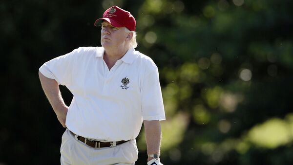  In this June 27, 2012, file photo, Donald Trump stands on the 14th fairway during a pro-am round of the AT&T National golf tournament at Congressional Country Club in Bethesda, Md. A set of golf clubs that Trump gifted to a former caddie before becoming president is being auctioned off. Boston-based RR Auction says Trump used the TaylorMade RAC TP ForgedIrons clubs at the Trump National Golf Club in Bedminster, New Jersey - Sputnik International