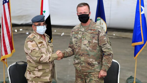 Maj. Gen. Kenneth P. Ekman, Deputy Commander of the Combined Joint Task Force-Operation Inherent Resolve, shakes hand with Brigadier General Salah Abdullah during the ceremonial handover of the Taji military base from US-led coalition troops to Iraqi security forces, at a base north of Baghdad, Iraq, 23 August 2020 - Sputnik International