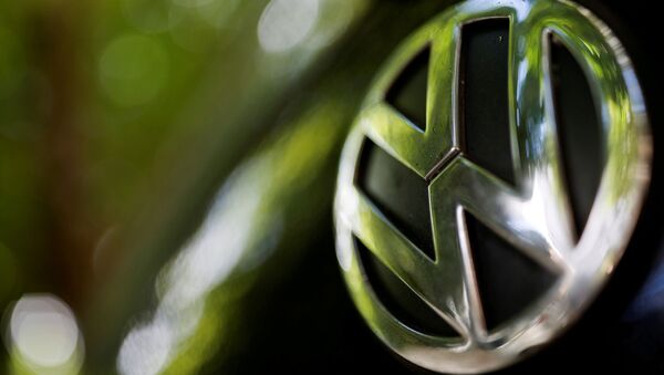 A logo of German carmaker Volkswagen is seen on a car parked on a street in Paris, France, July 9, 2020 - Sputnik International