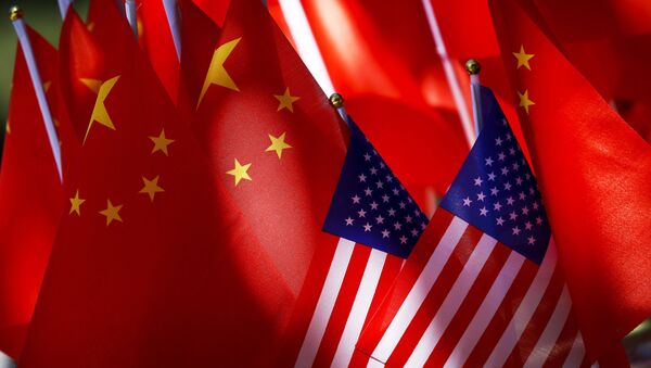  In this Sept. 16, 2018, file photo, American flags are displayed together with Chinese flags on top of a trishaw in Beijing. China’s Commerce Ministry said Thursday, Nov. 15, 2018, that high-level trade talks between Washington and Beijing have resumed - Sputnik International