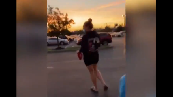 Screenshot from a video showing two women snatching a MAGA hat from a seven-year-old boy outside the Democratic National Convention site - Sputnik International