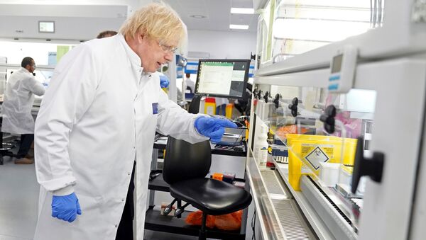 A handout image released by 10 Downing Street, shows Britain's Prime Minister Boris Johnson wearing PPE (personal protective equipment), including eye protection and gloves, during his visit to the UK Biocentre in Milton Keynes, north of London, on June 12, 2020, being used as a Lighthouse Lab facility dedicated to the testing for COVID-19.  - Sputnik International