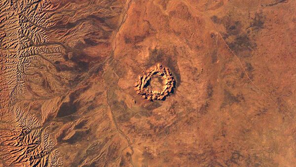 This handout image courtesy of NASA's Earth Sciences and Image Analysis Laboratory obtained 16 June 2003 shows Gosses Bluff, an impact crater in Australia's Northern Territory - Sputnik International